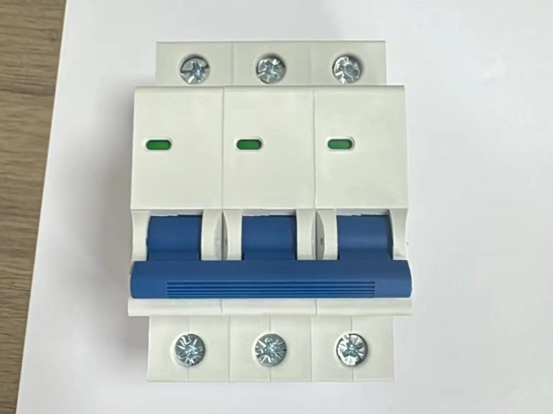 White 3-pole miniature circuit breaker with a blue linked handle, six screw terminals, and three green indicator windows. Z-curve, Z63 label.