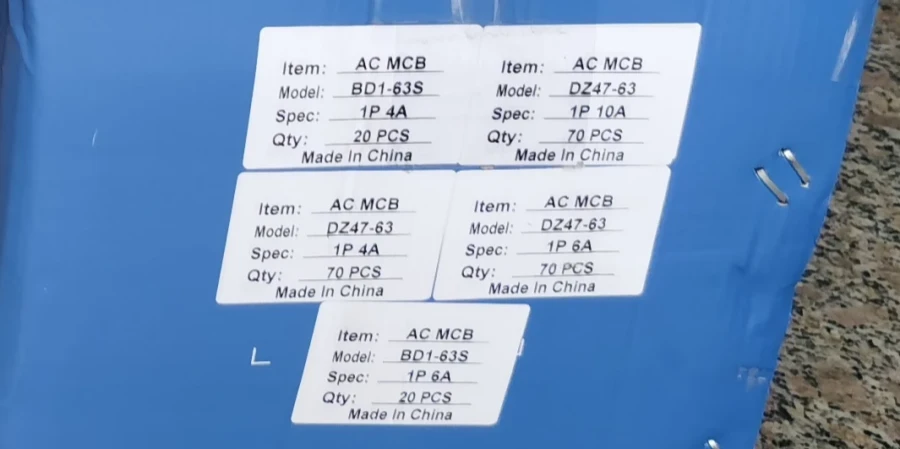 A blue box with five white product labels showing details for AC MCB models BD1-63S and DZ47-63, including specs like 1P 4A, 1P 6A, and 1P 10A, with quantities and Made in China.