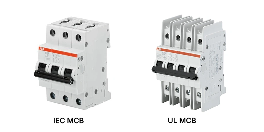 Two white three-pole miniature circuit breakers with black switches and orange labels, labeled IEC MCB on the left and UL MCB on the right, shown on a white background.