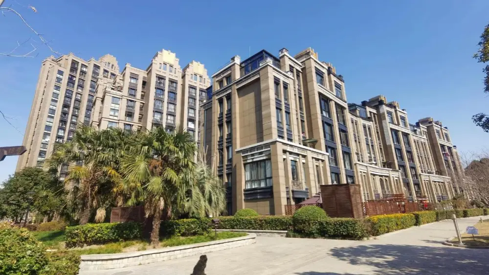 Modern high-end residential complex exterior view with landscaping and blue sky
