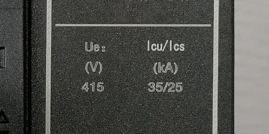 lose-up of a circuit breaker label showing Ue (V) 415 and Icu/Ics (kA) 35/25.