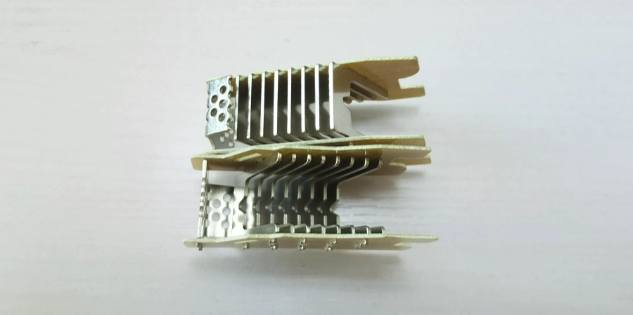 Two arc chutes with stacked metal splitter plates and perforated side panels, positioned one above the other on a white surface.